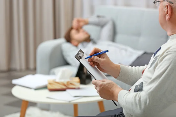 depositphotos_97378460-stock-photo-man-lying-on-sofa-at
