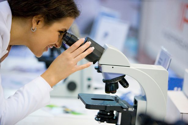 Scientist looking through a microscope, selective focus, canon 1Ds mark III