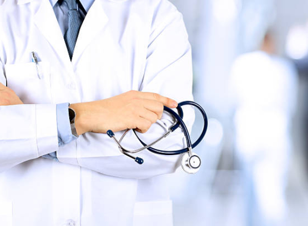 Portrait an unknown male doctor holding a stethoscope behind